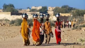 AI4WaterPolicy women carrying water from distant areas