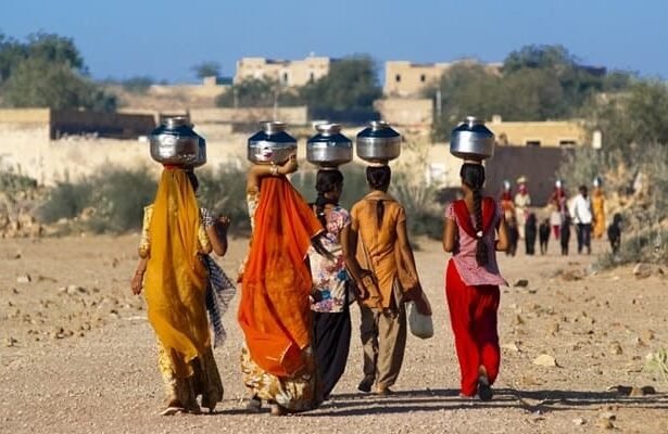 AI4WaterPolicy women carrying water from distant areas
