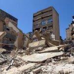 the image consists of a visual from middle east war with damaged buildings and destroyed infrastructure