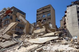 the image consists of a visual from middle east war with damaged buildings and destroyed infrastructure